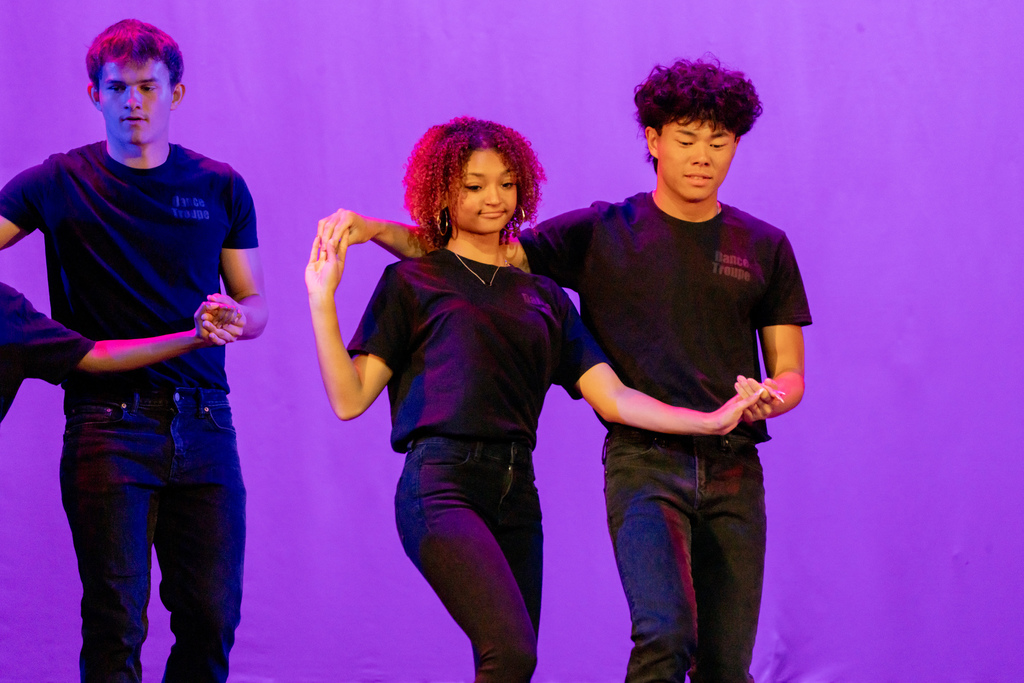 Two dance troupe performers dance on stage in Kirk. 