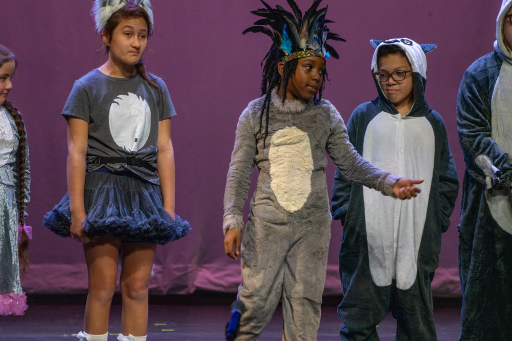 Blind Elementary dressed in costumes like animals perform on stage in Kirk. 