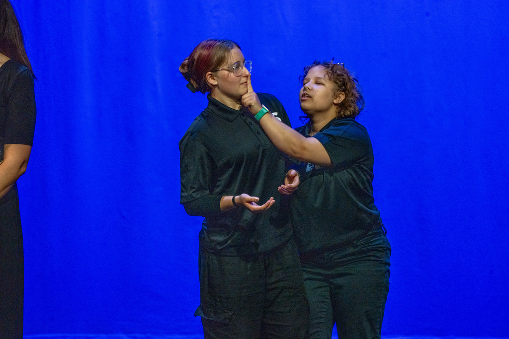 Two blind high school students act on stage in Kirk. 