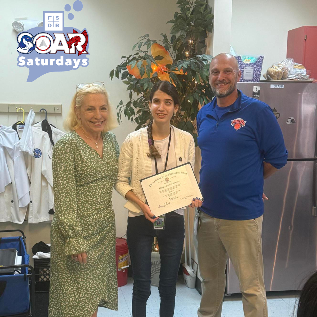 Photo of President of BHS and Assistant Principal of BHS smile with Melissa who is holding her diploma inside the classroom,.