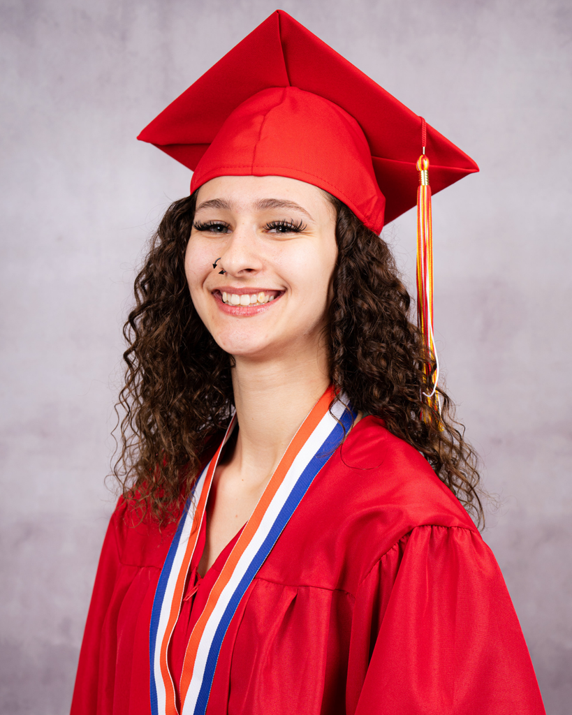 Skylar smiles for her photo wearing her red cap and gown. 