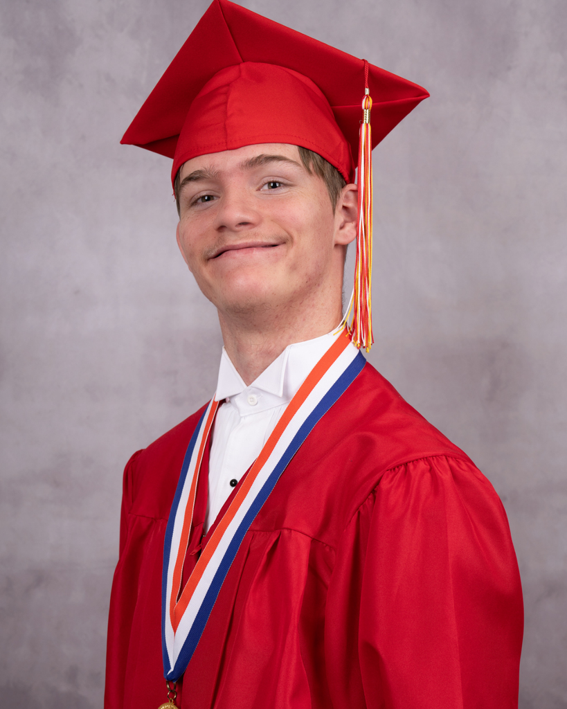 Alexzander smiles for the photo wearing his red cap and gown. 