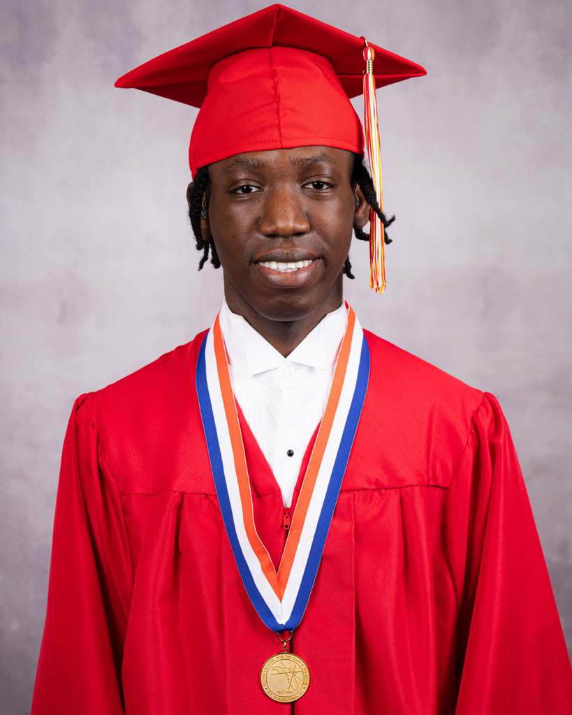Hakeem is smiling for his photo wearing his red cap and gown. 