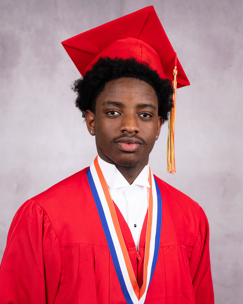 Manksy smiles for his photo wearing his red cap and gown. 