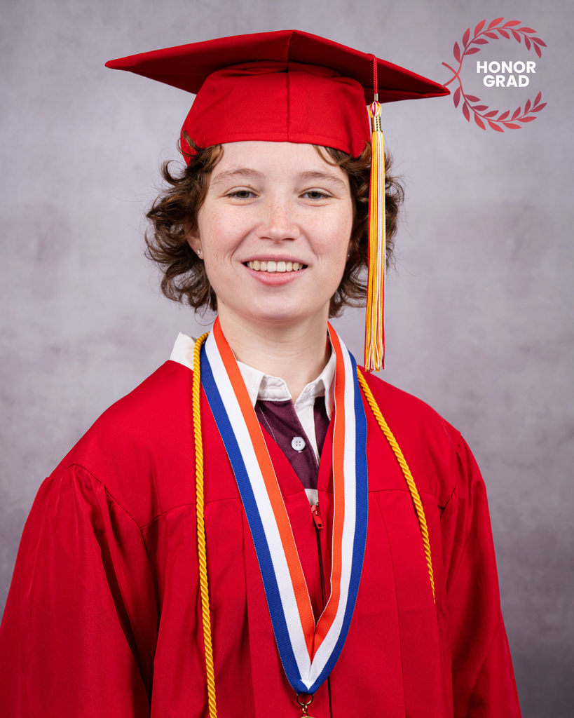 Jocelyn smiles for her photo wearing her red cap and gown. 