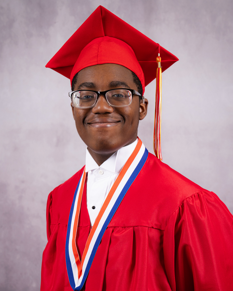 Joshulah is smiling for his photo wearing his red cap and gown. 