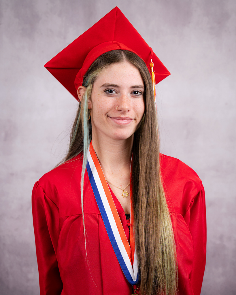 Priscilla smiles for her photo wearing her red cap and gown. 