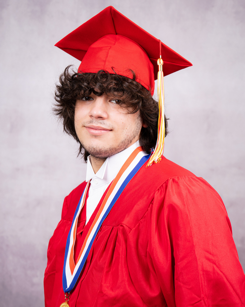 Nathaniel smiles for his photo wearing his red cap and gown.