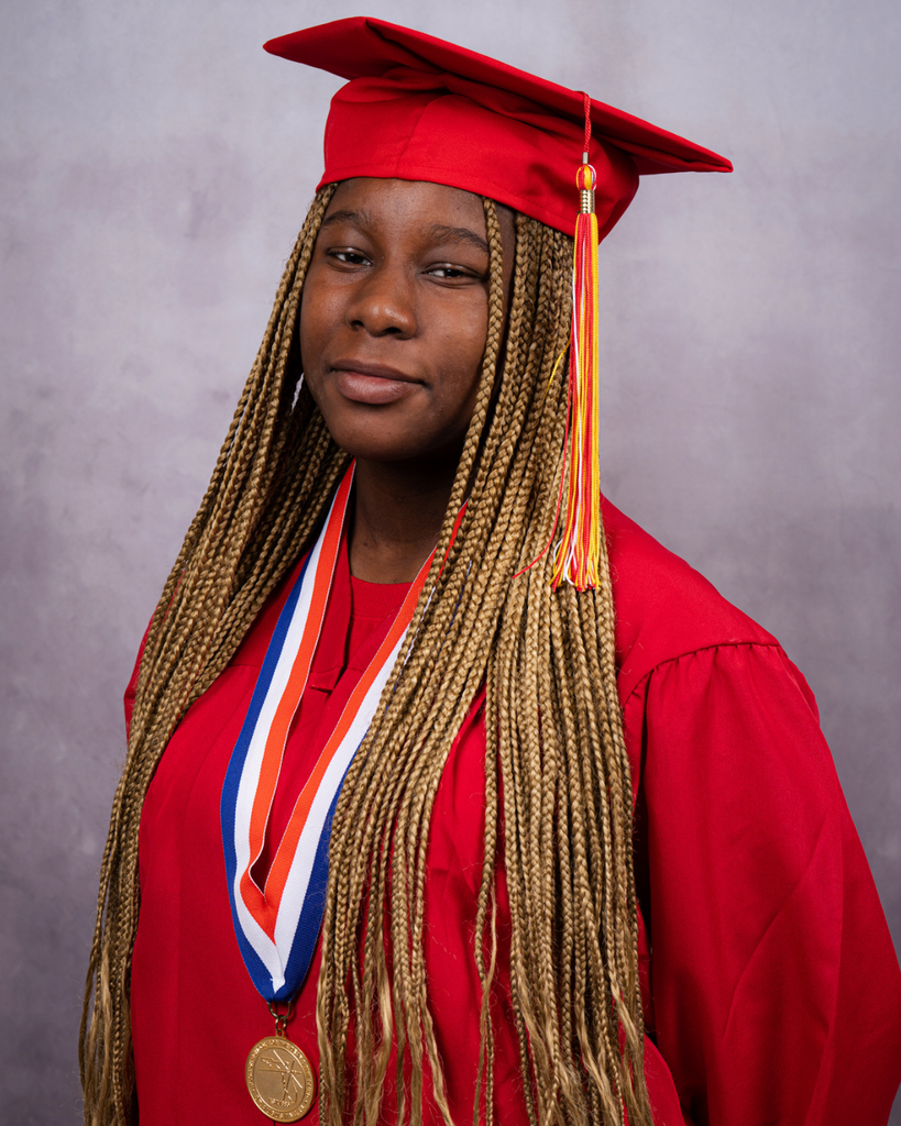 Marshanti smiles for her photo in her red cap and gown.