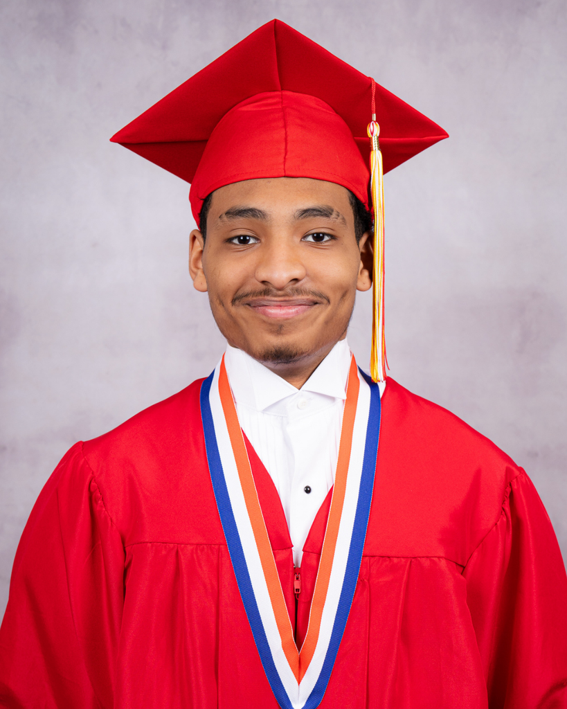 Antonio smiles for his photo wearing a red cap and gown.
