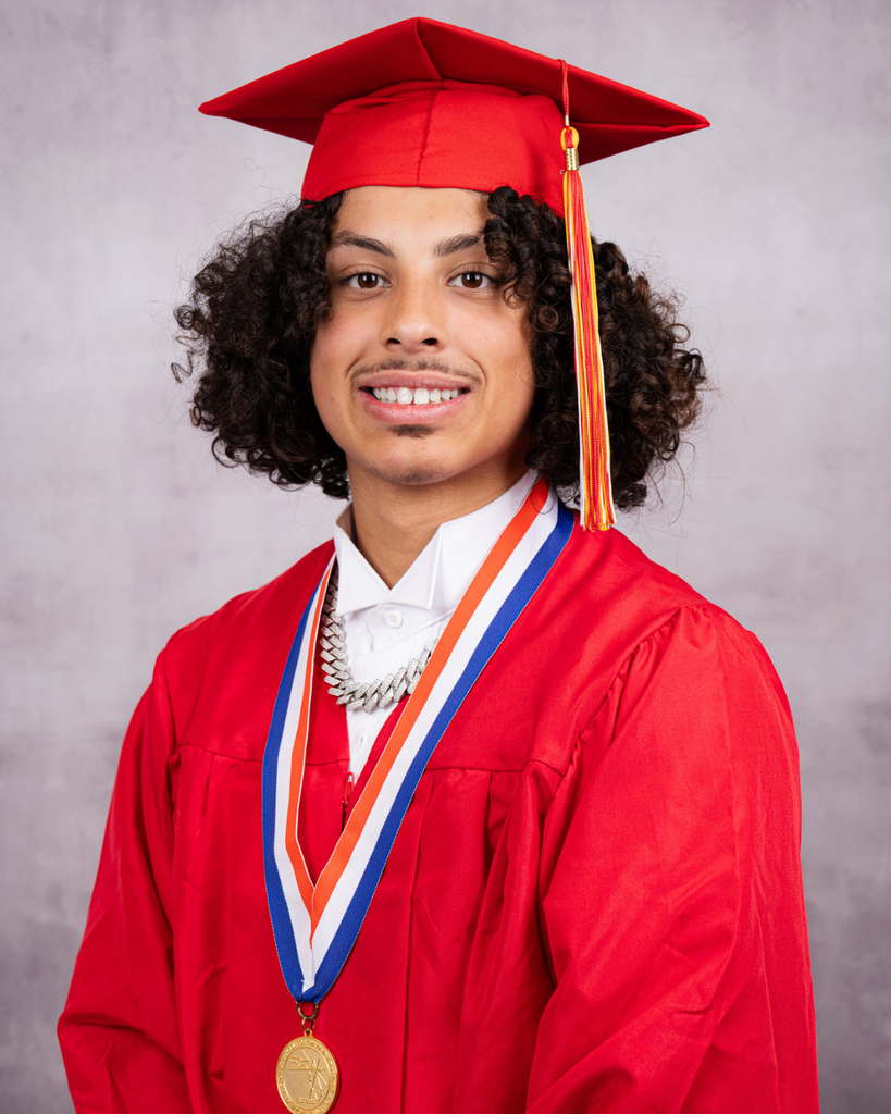Jayden smiles with his red cap and gown.