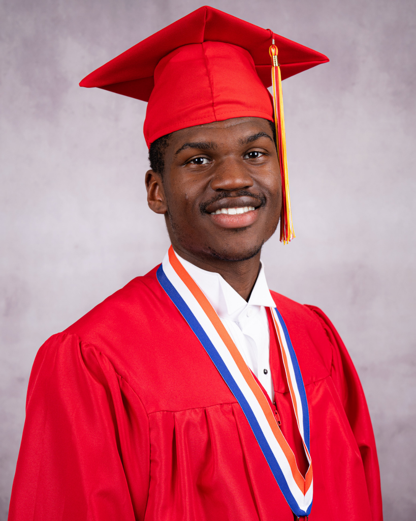 Ja'Morien smiles with his red cap and gown.