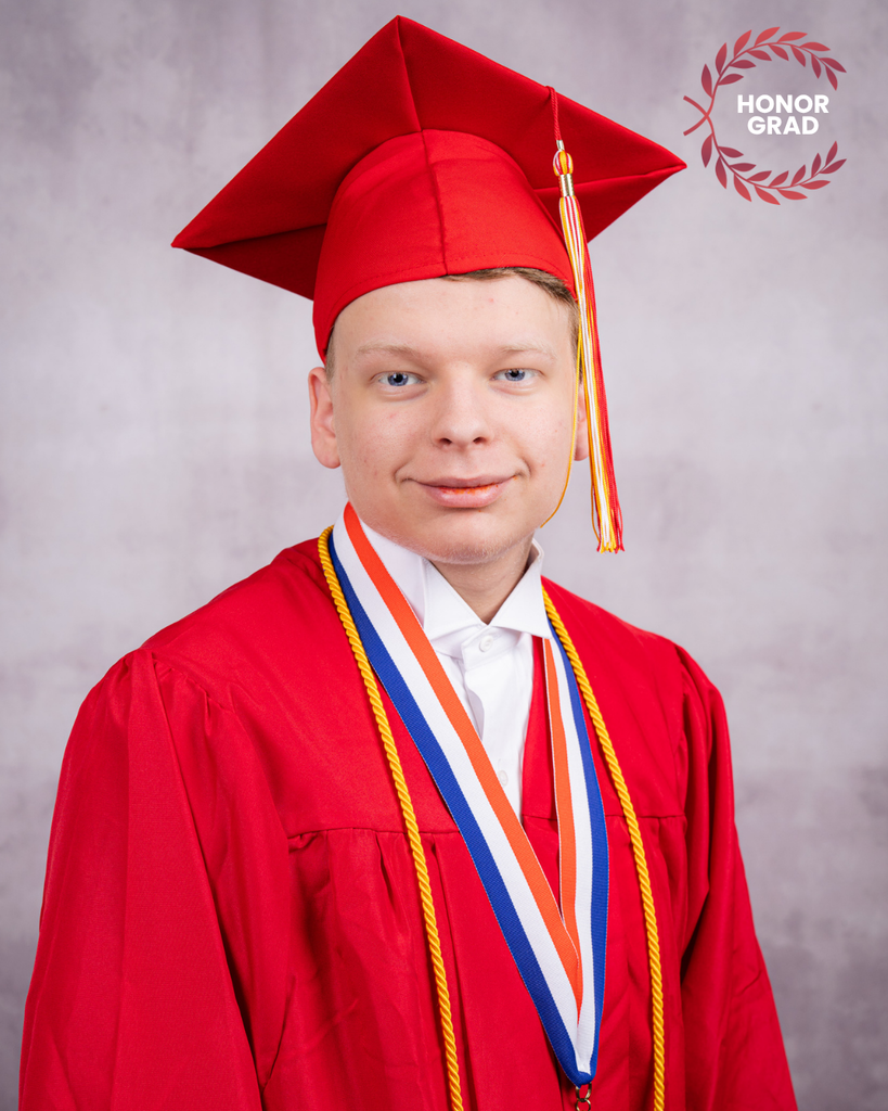 Dakota smiles with his red cap and gown.