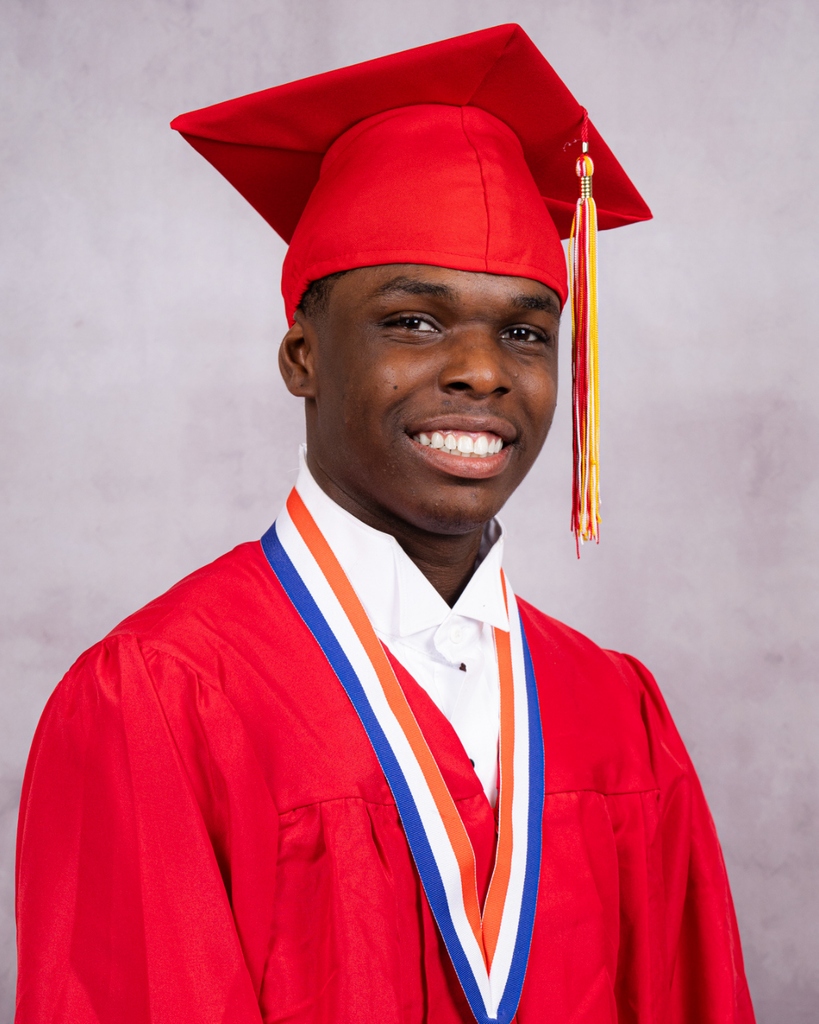 Semaji smiles for his photo wearing his red cap and gown. 