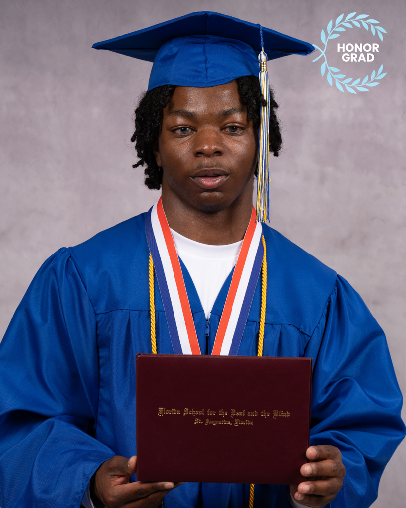 Khayree smiles for his photo with his blue cap and gown holding his diploma , and the "Honor Grad" logo at the top right corner.