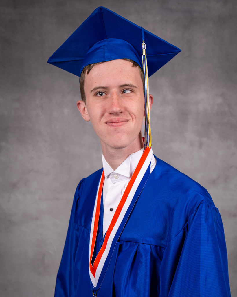 Mason smiles for his photo in his blue cap and gown.
