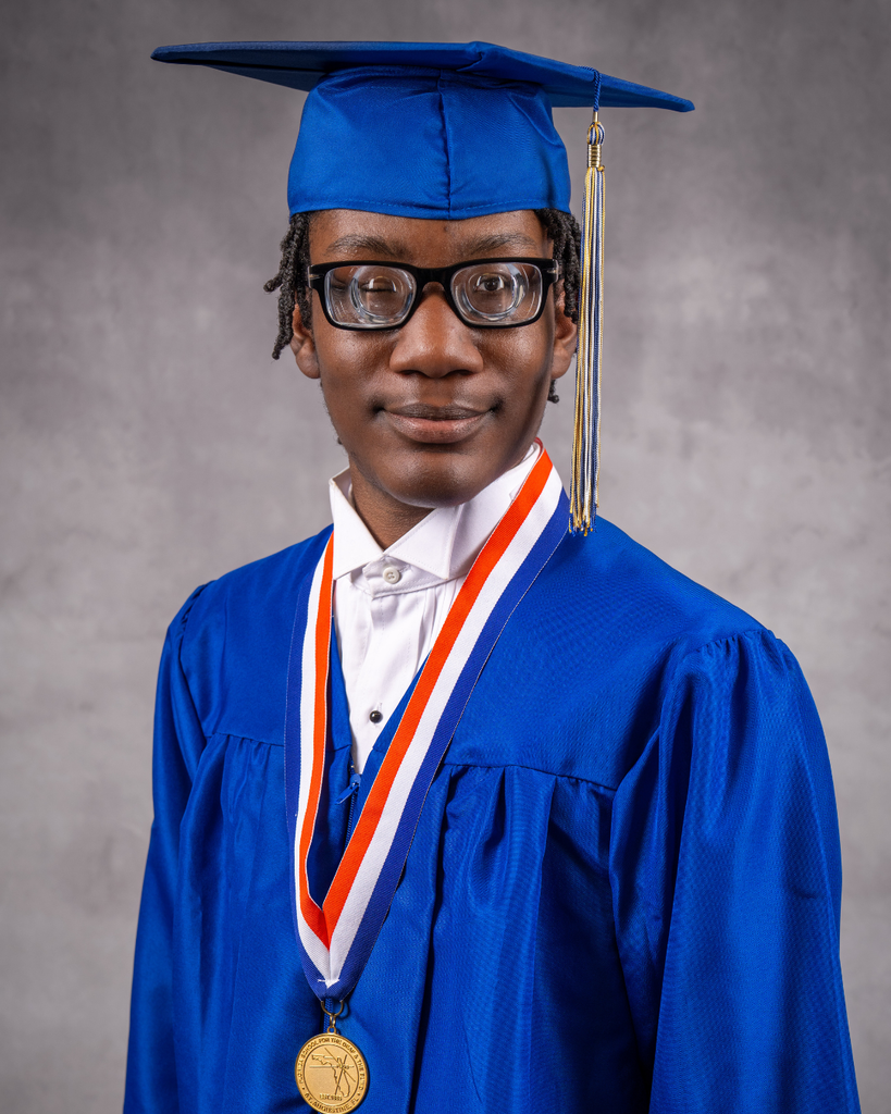 Jeremiah smiles for his photo in his blue cap and gown. 