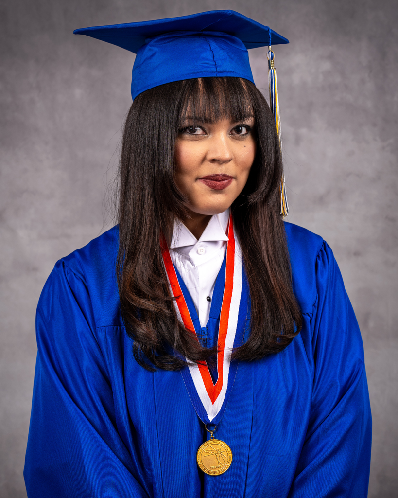 Rihanna smiles for her photo wearing her blue cap and gown.