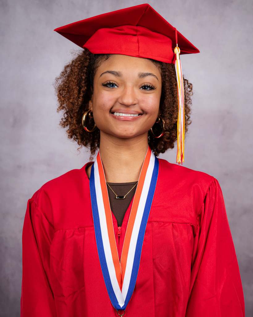 Giovanna is smiling for her photo wearing her red cap and gown.