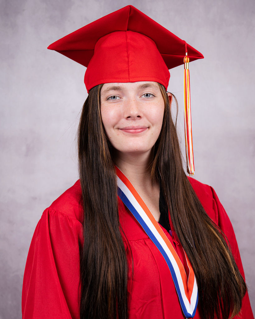 Cierra is smiling for her photo wearing her red cap and gown. 