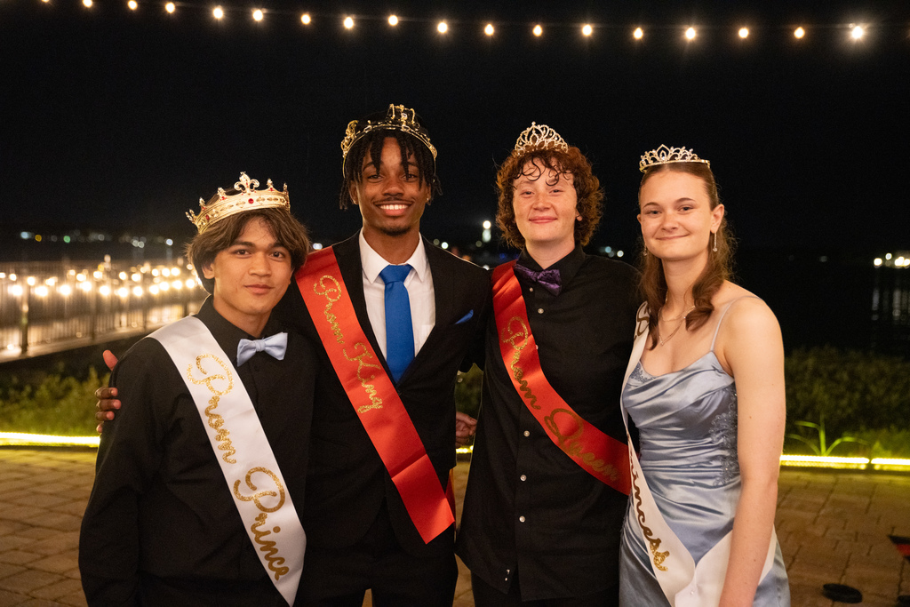 Prom King, Queen, Princess and Prince all smile together for a photo outside of River House. 