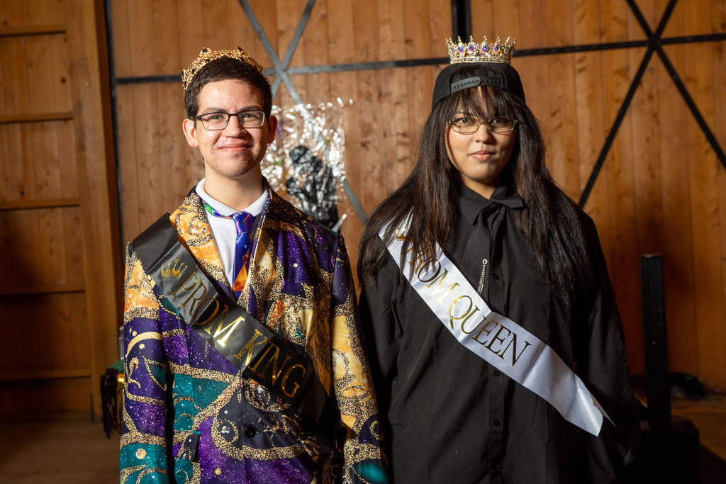 Prom King and Queen stand together for a photo inside the barn. 