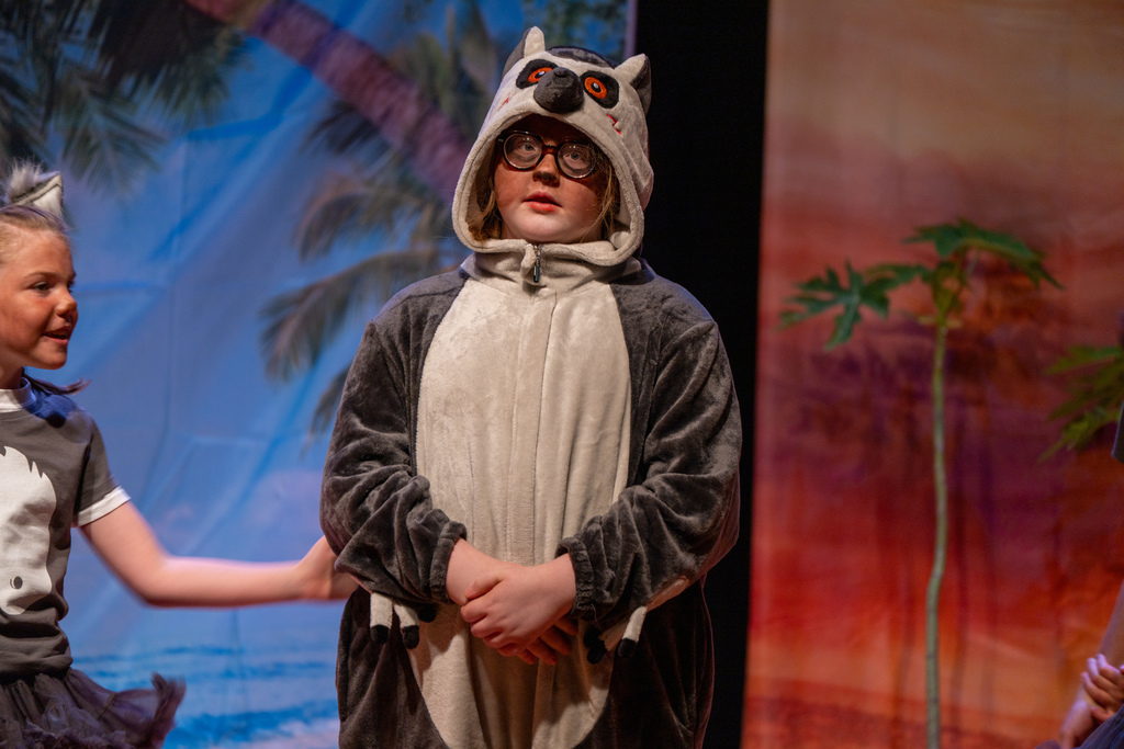 A student dressed like a kola bear on stage in the Music Building. 