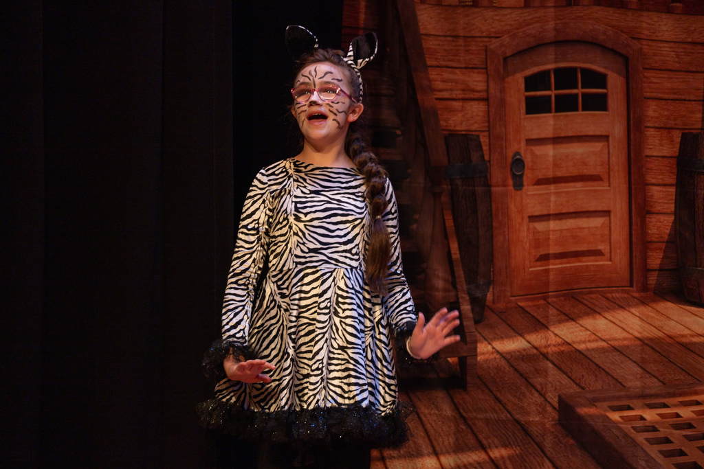 A student dressed like a zebra on stage in the Music Building. 