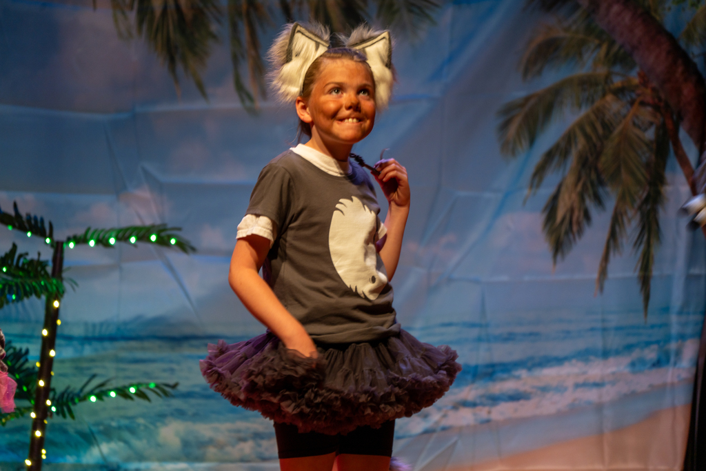 A student dressed like a kola bear on stage in the Music Building. 