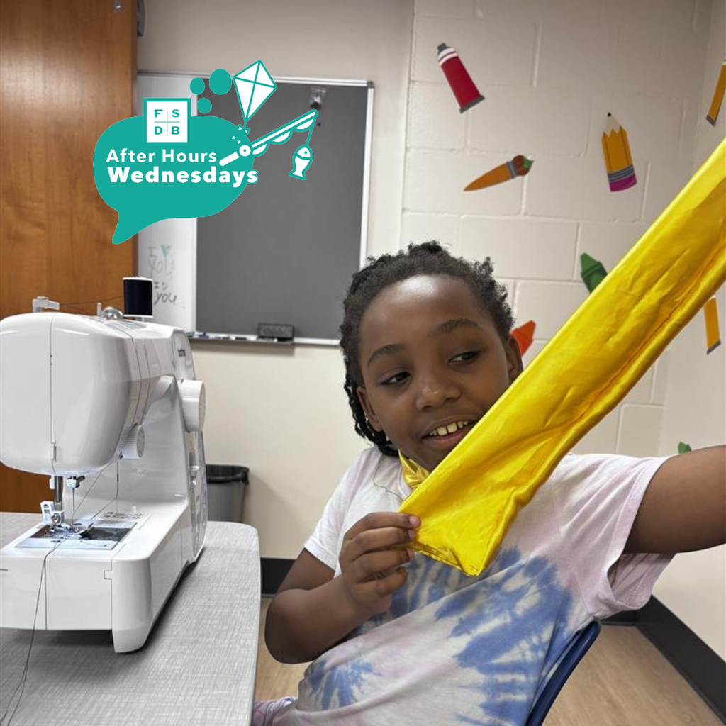 A student is working on a sewing project inside the dorms. 