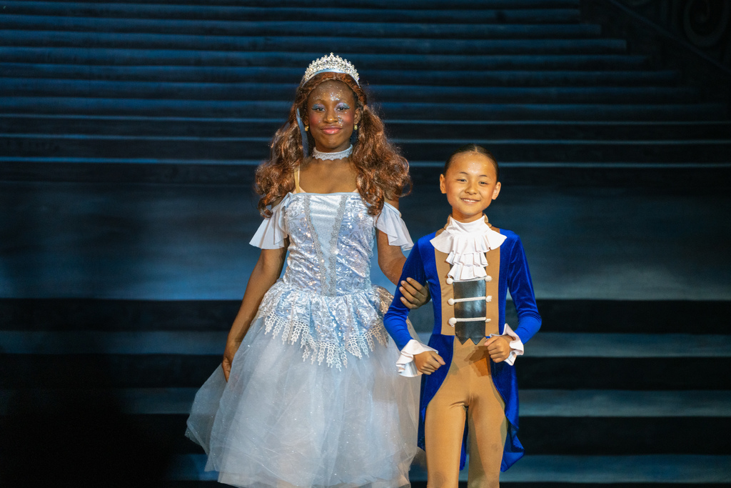 Two students dressed like Cinderella and the Prince on stage in Kirk.