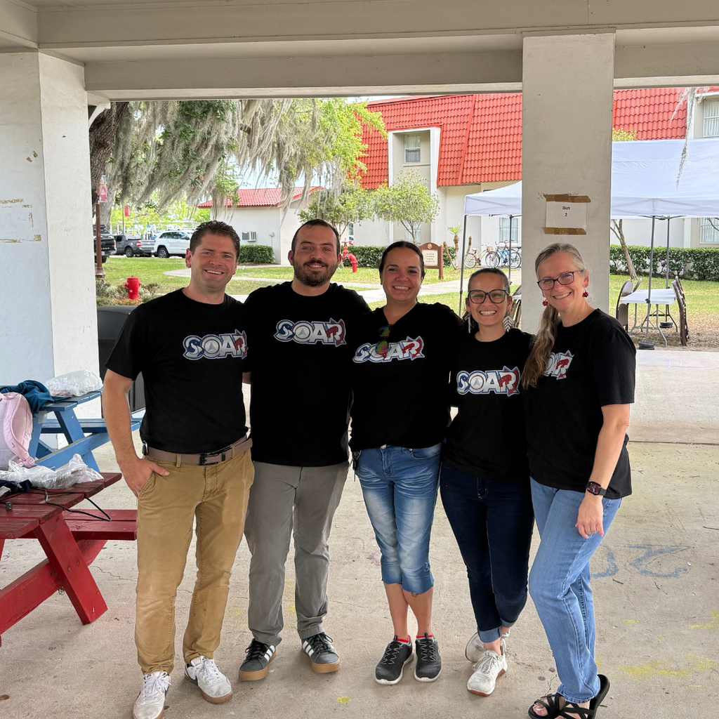 Group of SOAR staff members smile for a photo together outside the pavilion.