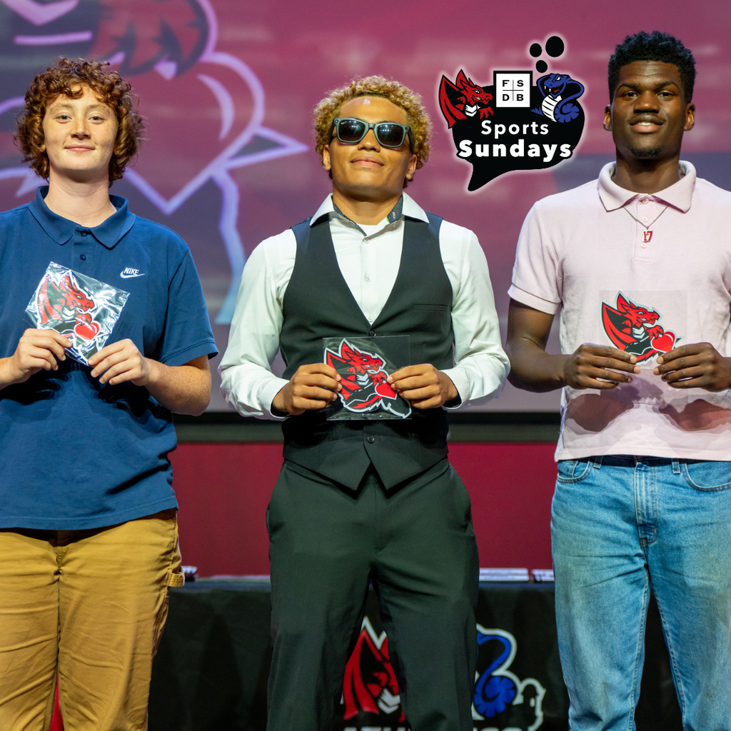 Three students hold a FSDB Dragon magnet smiling on stage in Kirk.