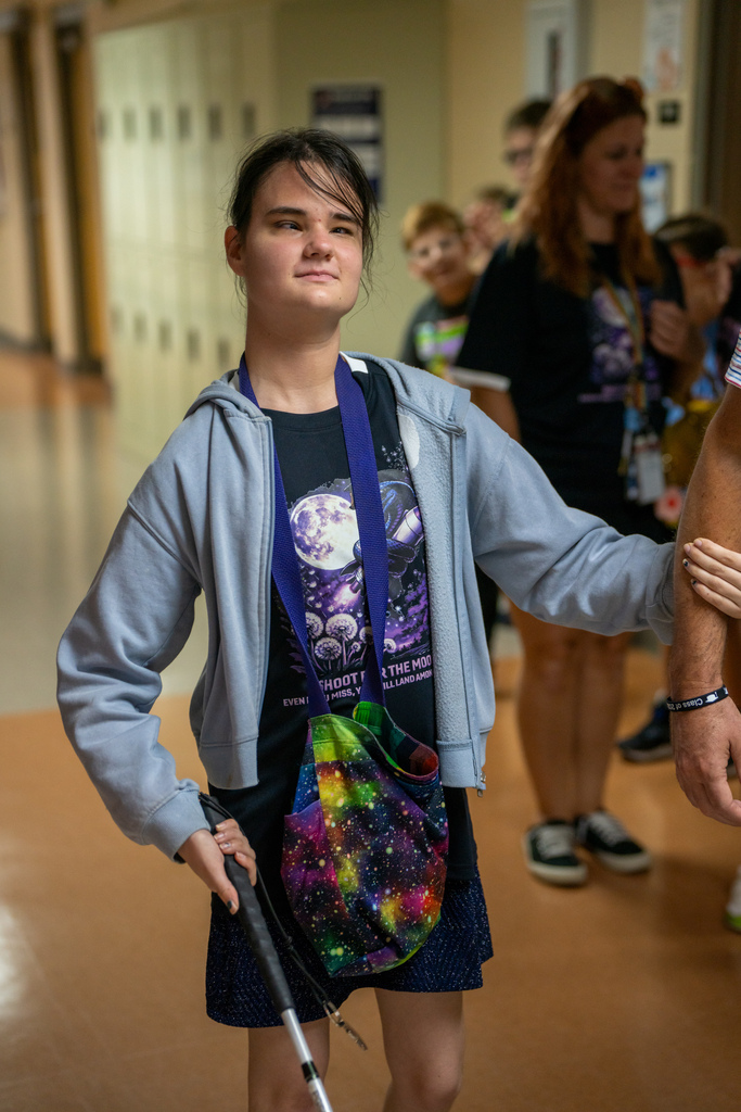A senior smiles as she walks down the hallway during Cobra Walk.