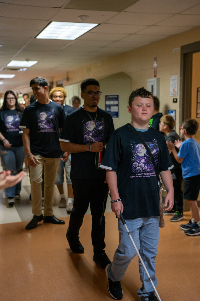 Seniors walk down the hallway during Cobra Walk.
