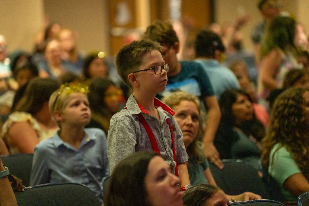 A student looks up to the stage in Kirk. 