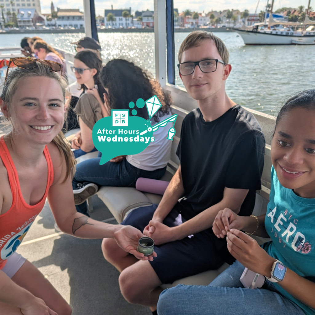 Students smile with a person who works for Florida Water Warriors on the boat. 