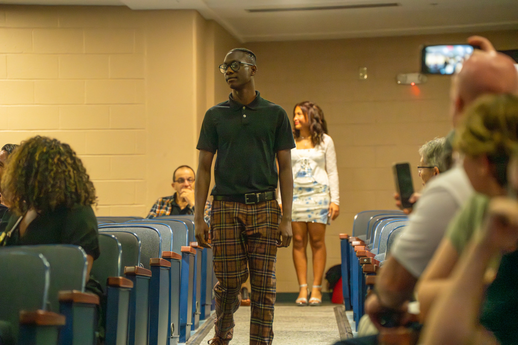 A 8th grader walking down the aisle in Kirk. 