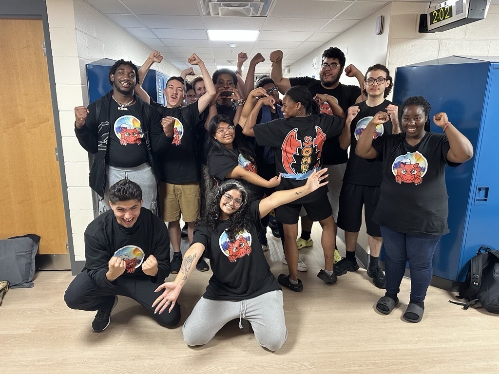 SOAR group wearing matching shirts excitedly smile for a photo before heading home for the summer. 