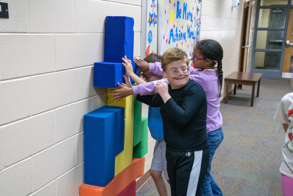 Students work together with foam blocks. 