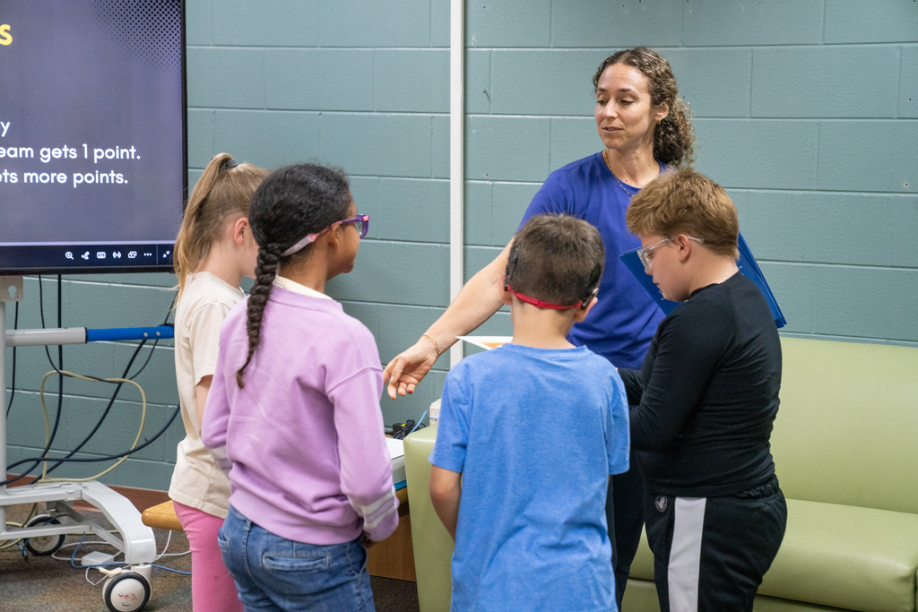Students listening to the teacher instructions for a game. 