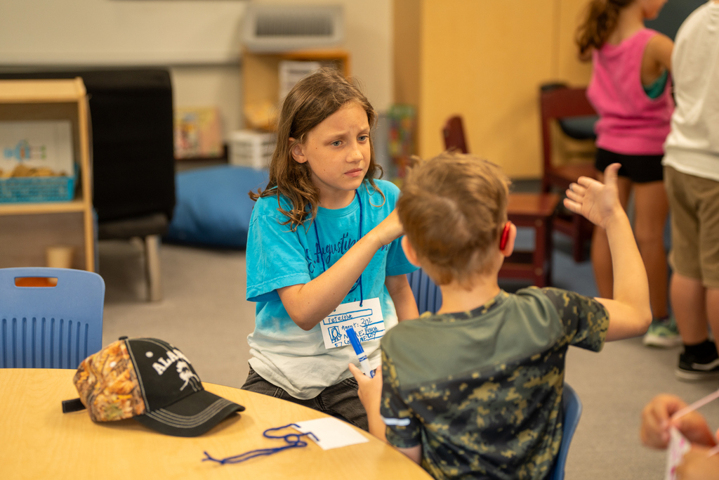 Students talk to each other inside the classroom. 