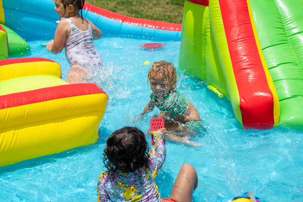 Students play in the water slide area. 