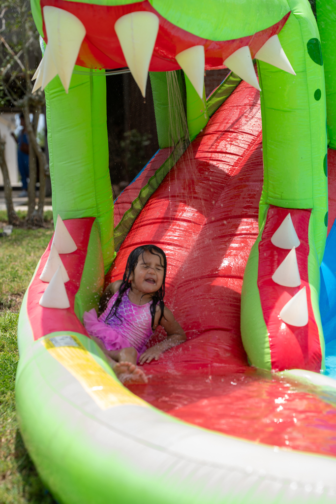 ELC student wearing mermaid bathing suit head down the water side. 