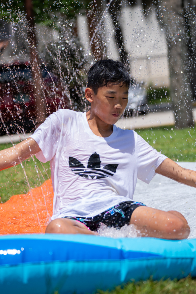 Student on slip and slide outside Palm Row.