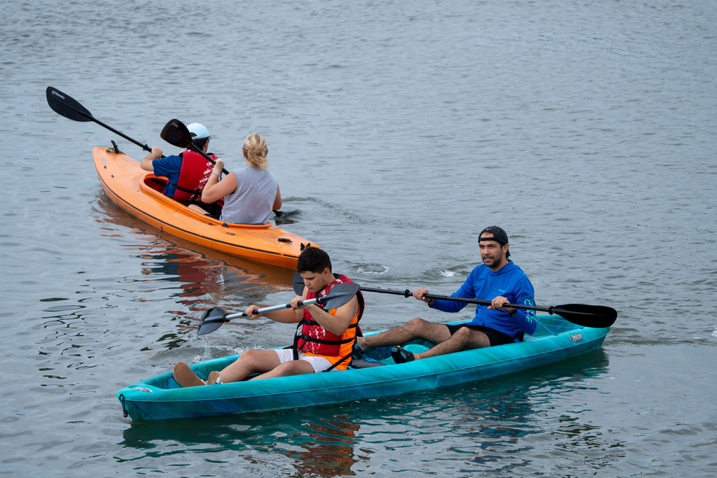 Two sets of campers and staff member out on the waters in the kayaks. 