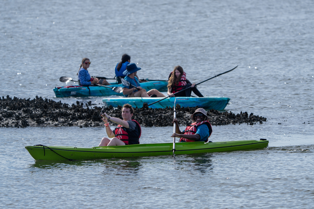 Three kayaks out on the waters. 