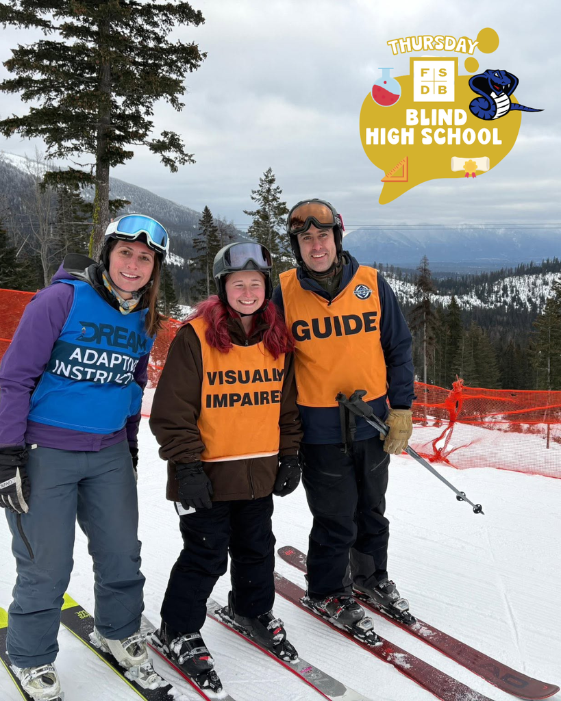 A Blind high school student smile with two staff members on the snowy mountain for their photo.