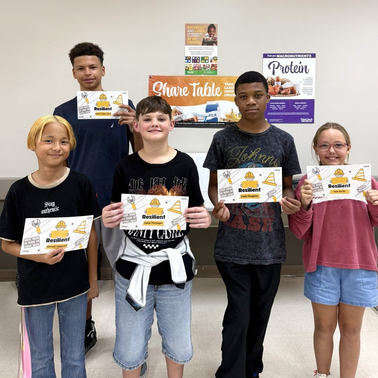 Five students stand together holding their Resiliency Awards.