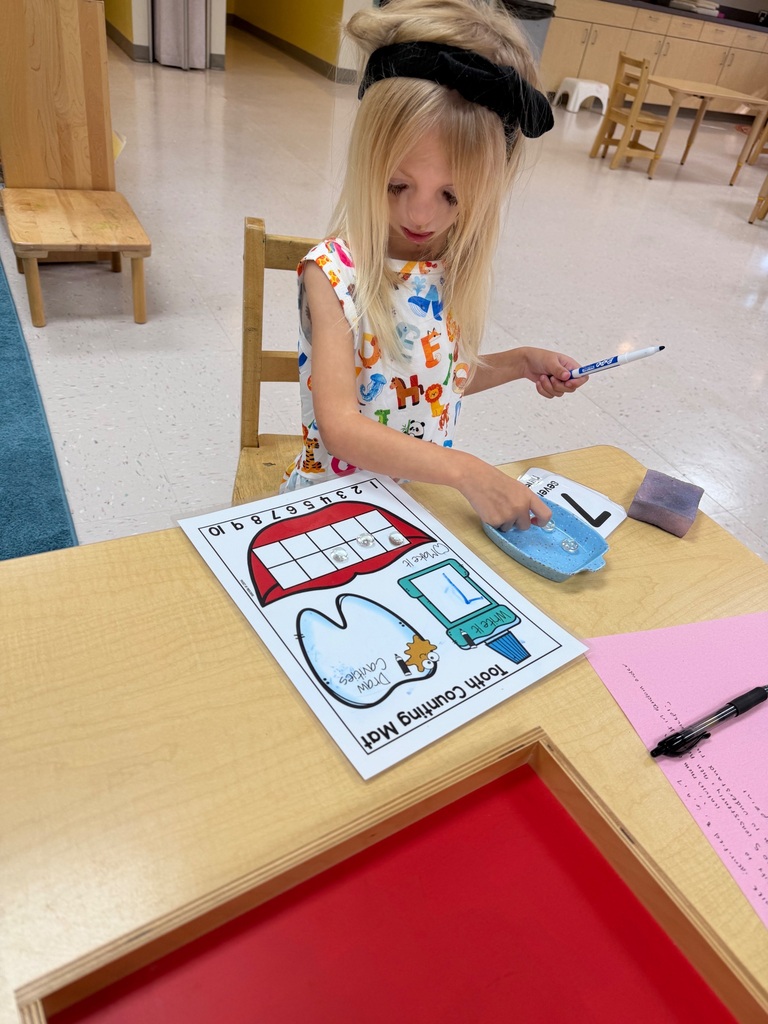 Student works on a counting assignment at a table. 